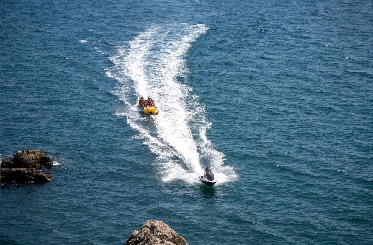 Jet ski towing an inflatable tube across the bay