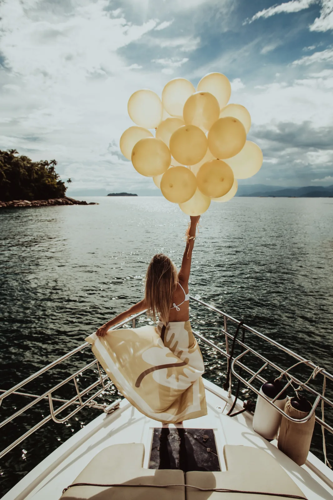 Group of friends celebrating on a yacht at sunset